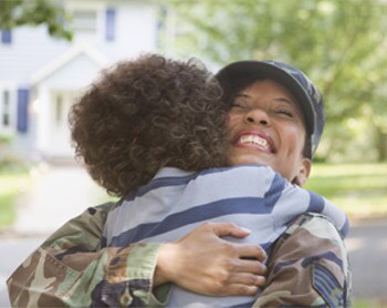 Soldier hugging her child.